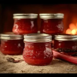Rhubarb Cinnamon Jam 2 Homemade rhubarb cinnamon jam in a jar with fresh rhubarb and cinnamon sticks
